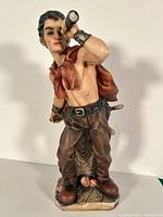 Full view of the ceramic pirate figurine standing, showing the overall figure, pose, and colors.
