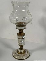 Full view of the decorative lamp showing clear glass chimney, brass, and mother of pearl inlay