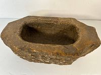 Top view showing the interior hollow and rectangular shape of the old stone bowl.