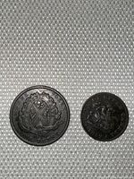 Topside view of the 1837 Canadian One Penny Bank Token and the 1852 Bank of Upper Canada Half Penny Bank Token showing their worn surfaces and dark patina.