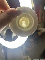 Close-up of bowl held against light showing detailed Geisha face silhouette inside bottom.