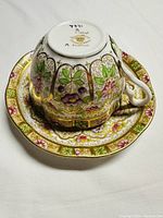 Bottom view of teacup on saucer showing Royal Albert maker's mark and intricate design.