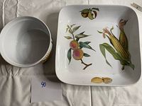 Photo showing the round ramekin and square platter side by side, highlighting the botanical designs and sizes