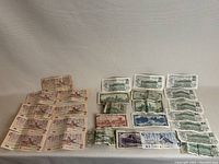 Eleven brown $2 notes with Queen Elizabeth II portrait and Ottawa 1986 imprint arranged in three rows with two extras at top