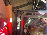 Side view of the Black and Decker portable workbench showing metal clamps and foldable legs in a storage or workshop environment