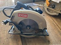 Photo of Ryobi circular saw showing blade, handle, and power cord.