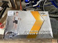 Photo of original packaging box showing Iron Body Balance Stepper and image of woman exercising on stepper.