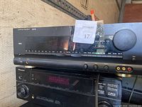 Full front and upper view of the Harman Kardon stereo receiver showing controls, headphone and microphone inputs, and general condition.