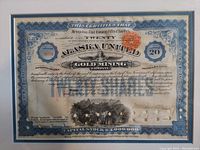 Close-up of the antique stock certificate showing detailed border, text, signatures, and red seal stamp.