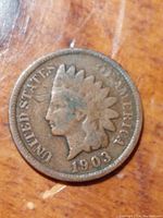 Front view of the 1903 Indian Head Penny showing the obverse with Lady Liberty's profile and the date 1903 with visible wear and patina.