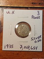 Front side image showing the inscription 'THREE PENCE 1935' with three oak leaves and acorns design on the silver coin.