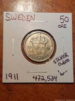 Front view of 1911 Swedish 50 Ore silver coin in protective holder with handwritten annotations.