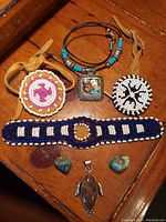 Top-down view of all jewelry items on wood surface showing detailed beadwork and stones.