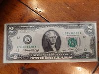 Front side of the vintage US two-dollar bill showing the portrait of Thomas Jefferson and serial number.