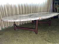 Overall view of oval marble top coffee table and walnut base