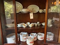 Full view of Noritake pieces displayed inside wooden hutch, top to bottom