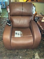 Front view of brown leather power lift recliner chair