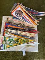 Overhead view of pennant pile showing assorted league and team logos