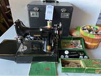 Singer Featherweight 221-1 machine on its base with spool of thread