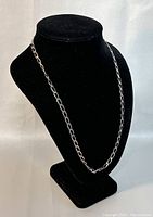 Photo of the 23 inch 925 silver necklace displayed on a black velvet necklace stand, showing chain length and style.