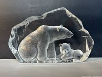 Front view of the lead crystal polar bear and cub figurine showing the bears clearly against a black background.