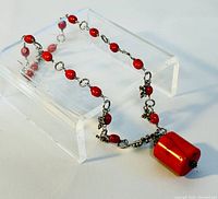 15 inch signed $ TRYNA coral necklace with red coral beads and a large rectangular coral pendant, silver-tone decorative chain links. Minor wear visible.