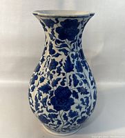 Front view of the vase showing the blue floral pattern over white ceramic surface with a flared rim.