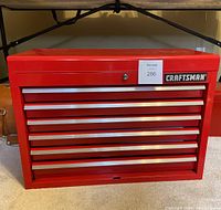Front view of the red Craftsman tool chest showing six drawers with silver handles and lock on top lid.