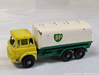 Yellow cab with white tanker and BP logos on the sides, angled front side view showing paint wear.