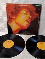 Front of album cover featuring close-up of Jimi Hendrix in orange/red tones