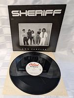 Image of the vinyl record with white Capitol label visible, laid on paper sleeve.