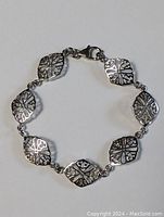 Full view of the sterling silver bracelet showing all diamond-shaped links and clasp.