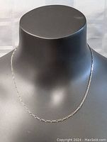 Sterling silver necklace displayed on a black mannequin neck to show length and fit.