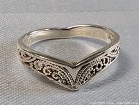 Side angled view showing the filigree and V-shaped design of the sterling silver ring marked 925.
