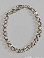 Full view of the sterling silver thick link bracelet laid flat.