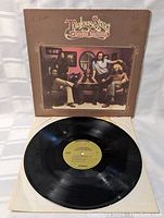 Vinyl record showing black grooves and yellow center label for The Doobie Brothers Toulouse Street album.