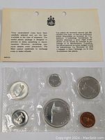 Sealed plastic packaging showing 1967 Canadian uncirculated coin set with card insert text about coin selection and tarnish prevention.