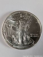 Front (obverse) of the 1993 Walking Liberty Silver Dollar showing Liberty walking with sun in background and date 1993.