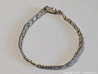 Full view of the bracelet laid out in a circular shape showing the clasp and nugget texture.