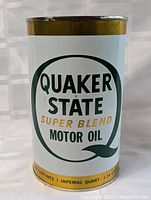Full front view of the Quaker State Super Blend Motor Oil tin showing logo and label.