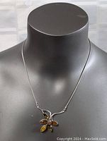 Full view of necklace on display bust showing pendant and chain.