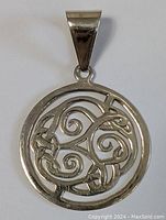 Front view of the sterling silver pendant showing the Celtic knot and spiral openwork design with polished finish and wide bail.