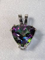 Front view of triangular faceted topaz pendant set in sterling silver with vibrant multicolor gemstone.