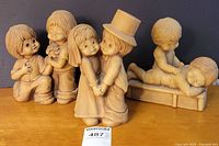 Wide view showing all three FannyKins figurines on display: The Proposal, Together Forever, Tender Touch.