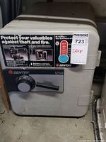 Front view of the Sentry combination lock safe with label and dial