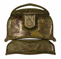 Top view of inkwell and pen tray showing embossed Art Nouveau pattern and bronze patina