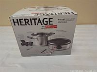 Box of Heritage Electric Fondue Set showing brand name, product image, and features
