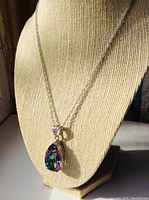 Front view of the necklace on a display mannequin showing chain and pendant.