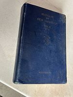 Front cover of the 1951 Manual of Seamanship Volume II, showing the blue textured hardcover with gold embossed text and anchor symbol.
