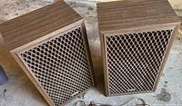 Front view of the pair of vintage Sears Professional Series stereo speakers showing wood grain finish and lattice front grills.